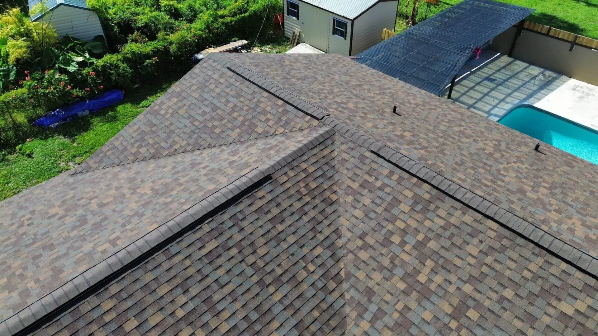 A top view of a house roof with trees around